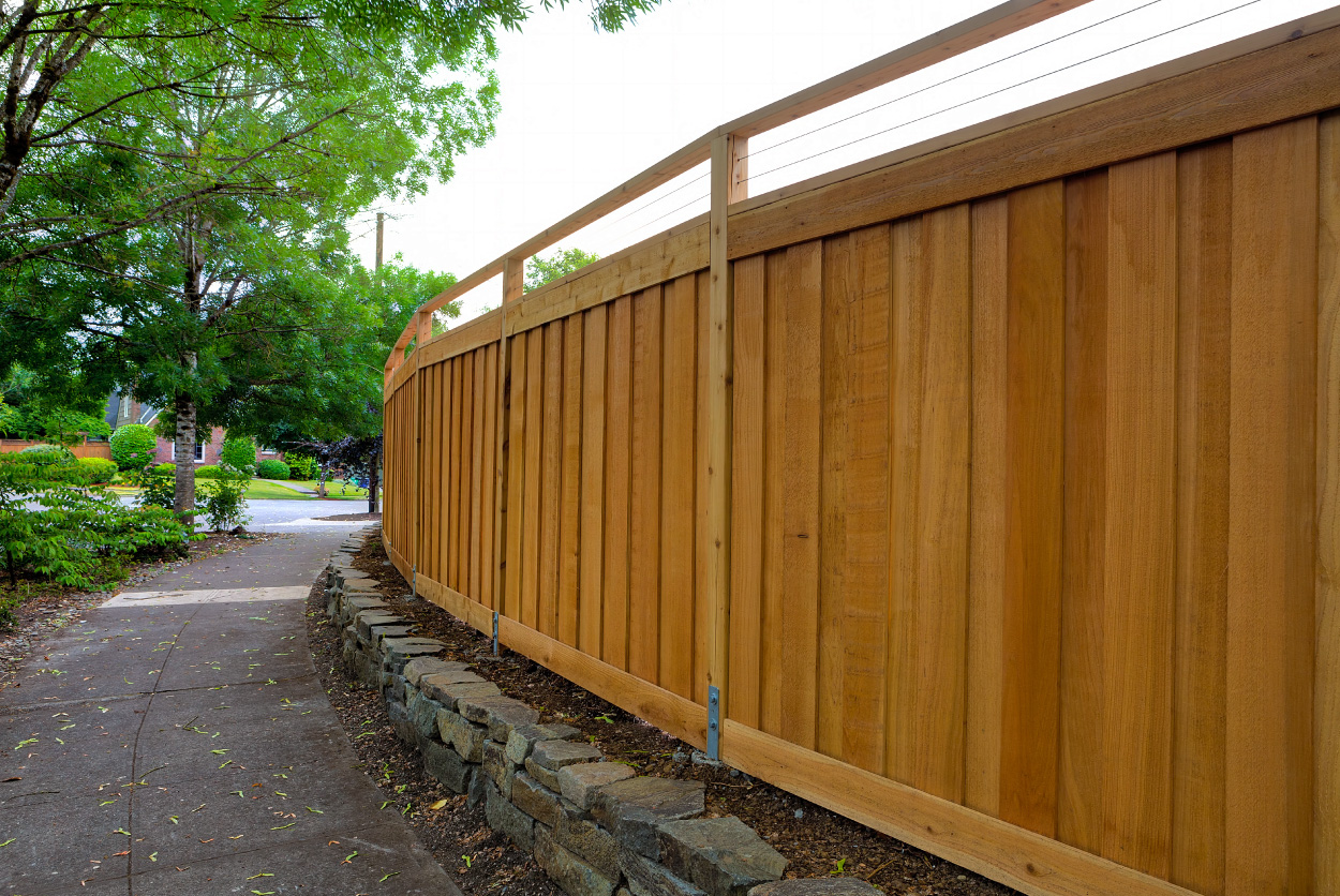 Wooden fencing with decorative stone base